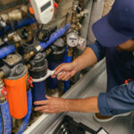 professional-plumber-repairing-water-supply-system-QEDHLWP.jpg